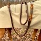Preview: Hund mit Hundeleine aus Tau espresso braun, Leder cognac braun mit Flechtungen und Beschlägen edelstahl und Regenmantel im Wald Preview: Hund mit Hundeleine aus Tau espresso braun, Leder cognac braun mit Flechtungen und Beschlägen edelstahl und Regenmantel im Wald